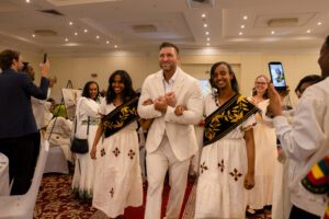 Tim Tebow walks the red carpet with CURE patients Haniel and Bereket.